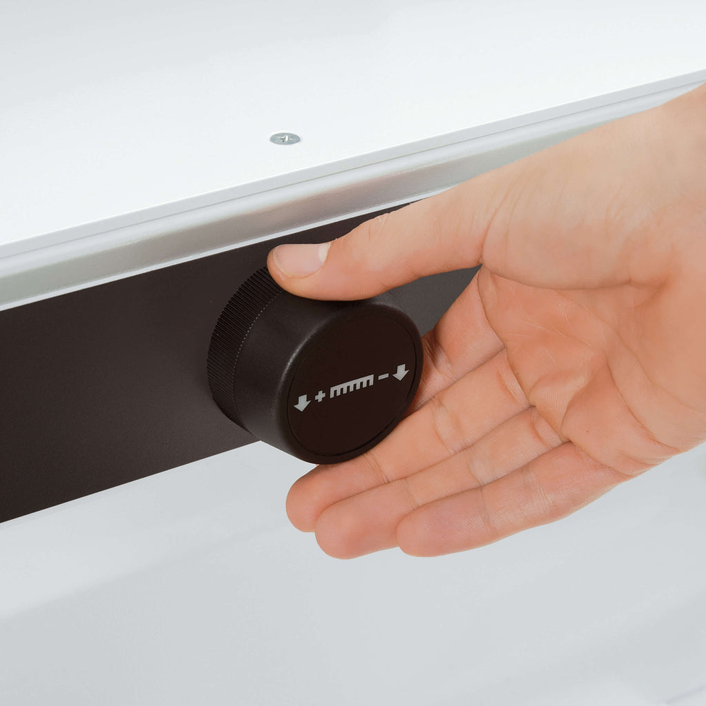 Nahaufnahme auf die Frontseite des elektrischen IDEAL-Stapelschneiders. Zoom auf eine Hand, die im Begriff ist, am elektronischen Handrad zu drehen.